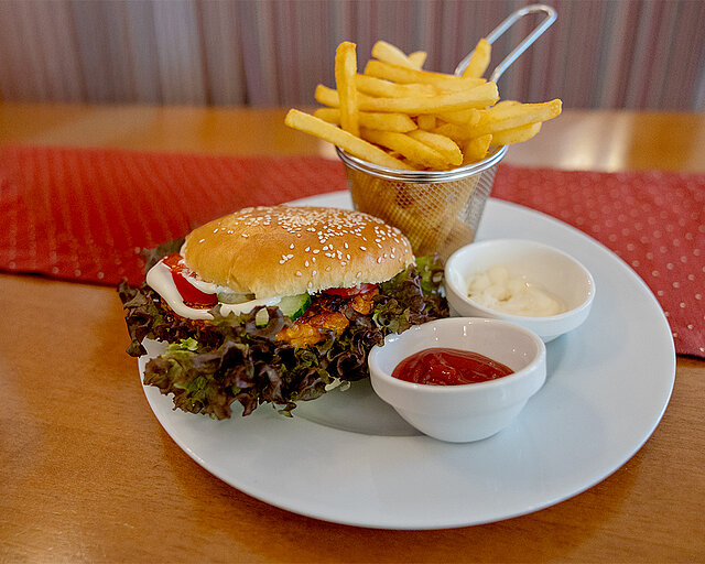 Crisp chicken burger with fries, ketchup, and mayo. Crispy chicken burger with fries, ketchup, and mayo.